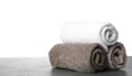 Rolled fresh clean towels for bathroom on table against background. Space for text Royalty Free Stock Photo