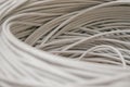 A rolled gray cable is a close up. A bunch of utp wires intertwined with each other. Abstract technological background texture. Royalty Free Stock Photo