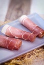 Rolled ham slices with herbs on a table