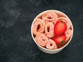 Rolled ice cream strawberry in cone cup on dark Royalty Free Stock Photo