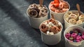 Rolled ice creams in cone cups on dark background Royalty Free Stock Photo