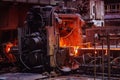 Rolled metal factory hot steel bar on conveyor moving through rollers Royalty Free Stock Photo