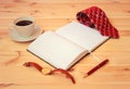 Rolled necktie, diary, watch, cup of coffee and pen on wooden table. Selective focus Royalty Free Stock Photo