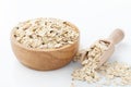 Rolled oat, raw oatmeal in wooden bowl with scoop