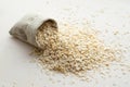 Rolled oats in burlap bag on wood table Royalty Free Stock Photo