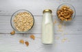 Rolled oats or oat flakes in bowl with oat milk and Cashew nuts on white wood background. Top view, horizontal. Healthy lifestyle Royalty Free Stock Photo