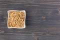 Rolled oats or oat flakes in bowl on wooden background Royalty Free Stock Photo