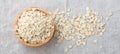 Rolled oats, oat flakes in wood bowl on linen cloth backgorund Royalty Free Stock Photo