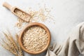 Rolled oats or oat flakes in wooden bowl on concrete background, top view Royalty Free Stock Photo