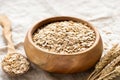 Rolled oats, oat flakes in wooden bowl Royalty Free Stock Photo