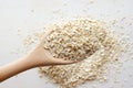 Rolled oats in wooden spoon over white background Royalty Free Stock Photo