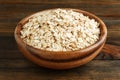 Rolled oats in a wooden bowl Royalty Free Stock Photo
