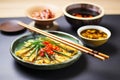 rolled omelette slices, chopsticks, soy sauce dip Royalty Free Stock Photo