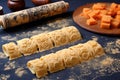 rolled out dough with pasta stamp impressions