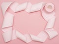 A rolled-out roll of pink toilet paper on a pink background. Copy space. Flat lay Royalty Free Stock Photo