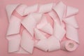 A rolled-out roll of pink toilet paper on a pink background. Hygiene products Royalty Free Stock Photo