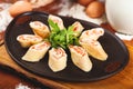 Rolled pancakes crepes, blini with smoked salmon and cream cheese on black plate