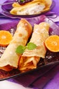 Rolled pancakes with orange