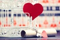 Rolled paper and red paper hearts, next to white retro bird cage. Royalty Free Stock Photo