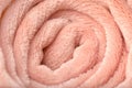 Rolled pink plush fabric, closeup