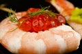 Rolled prawn sushi with salmon roe.