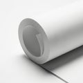 Rolled sheet of white paper on table Royalty Free Stock Photo