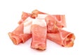 Rolled slices of Speck on white background. It is a smoked pork belly from the Tyrol and german tradition Royalty Free Stock Photo