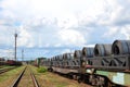 Rolled steel coil on on a freight train fixed by a chain.