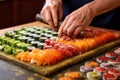 rolled sushi being sliced on a board