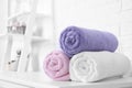 Rolled tidy towels on table in bathroom Royalty Free Stock Photo