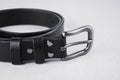 Rolled up black leather belt with buckle and rivets Royalty Free Stock Photo