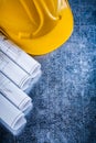 Rolled up construction drawings and safety hard Royalty Free Stock Photo