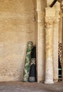 Rolled up prayer rugs in a corner of natural stone masonry in the Great Mosque of Sousse