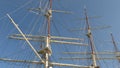 Rolled up sails at the sailing ship. Blue sky background Royalty Free Stock Photo