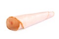 A rolled up single slice of chicken ham isolated on white