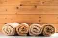 Rolled up bath towels on wooden background.