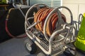 Rolled up water hose on a portable cart