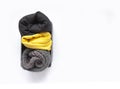 Rolled warm jumpers and t-shirts in small box. Home vertical storage Royalty Free Stock Photo