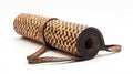 Rolled yoga mat with a textured brown pattern on a white background, ready for exercise Royalty Free Stock Photo