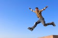 Roller boy jumping from parapet Royalty Free Stock Photo