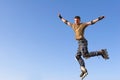 Roller boy jumping from parapet on the blue sky Royalty Free Stock Photo