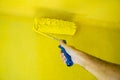 Roller Brush Painting, Worker on surface wall, renovating with yellow color Royalty Free Stock Photo