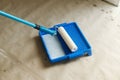 Roller brush and tray with prime close up for plaster walls. Construction of house and home renovation concept. Process of priming