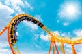 Roller coaster high in the summer sky at theme park most excited fun and joyful playing machine Royalty Free Stock Photo