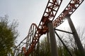 Roller coaster rails between trees with sun Royalty Free Stock Photo