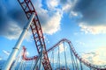 Roller coaster with a red track and white supports Royalty Free Stock Photo