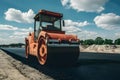 Roller compacting asphalt on road, construction site close up Royalty Free Stock Photo