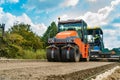 Roller, construction equipment, on the road repair site. Road repair machine with heavy vibration rollers compactor Royalty Free Stock Photo