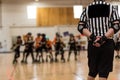 Roller derby referee watches team