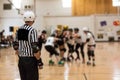 Roller derby referee watches team